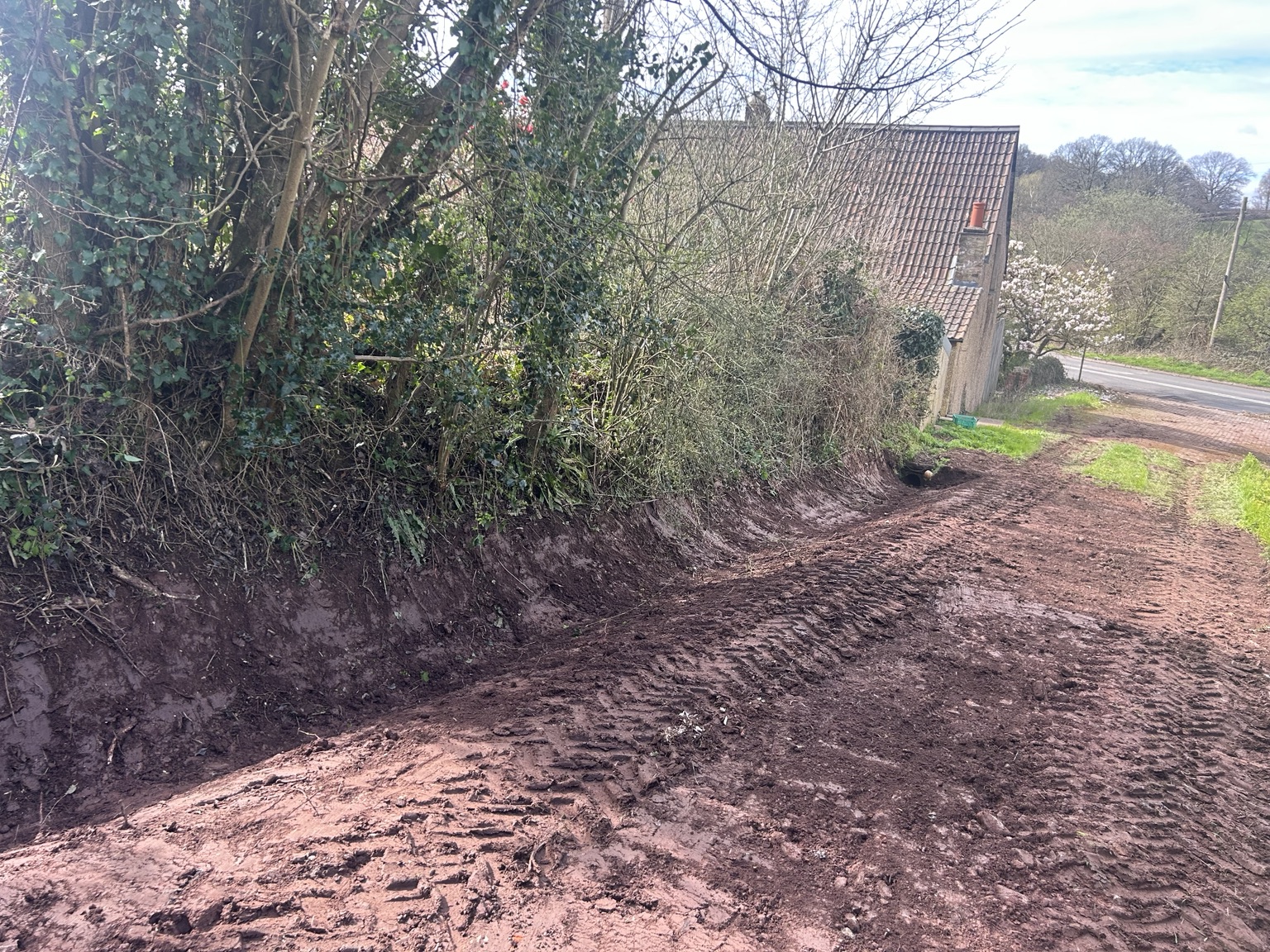 Restored open drainage ditch beside rural access track